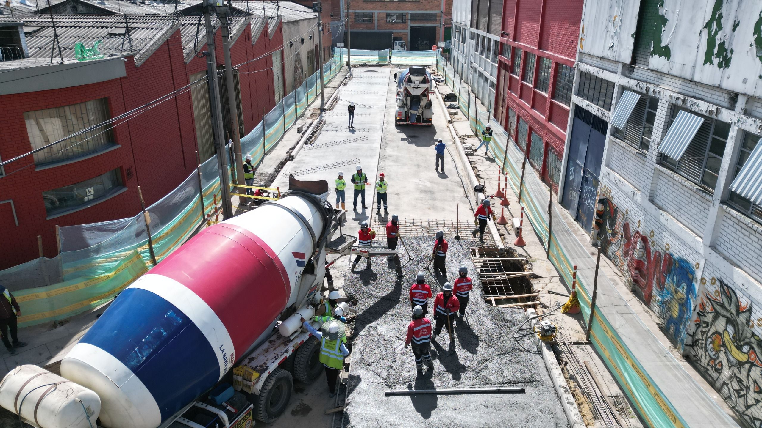 Un grupo de trabajadores funden cemento en una de las calles del grupo 4 de Zonas Industriales